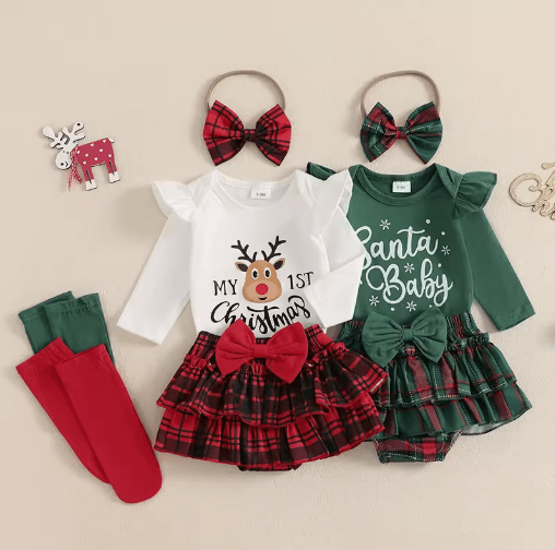 Baby girl wearing green and white Christmas outfit with reindeer print